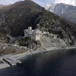 Dionysiou Monastery at the feet of Anti-Athos mountain, with snowy Athos at the back.