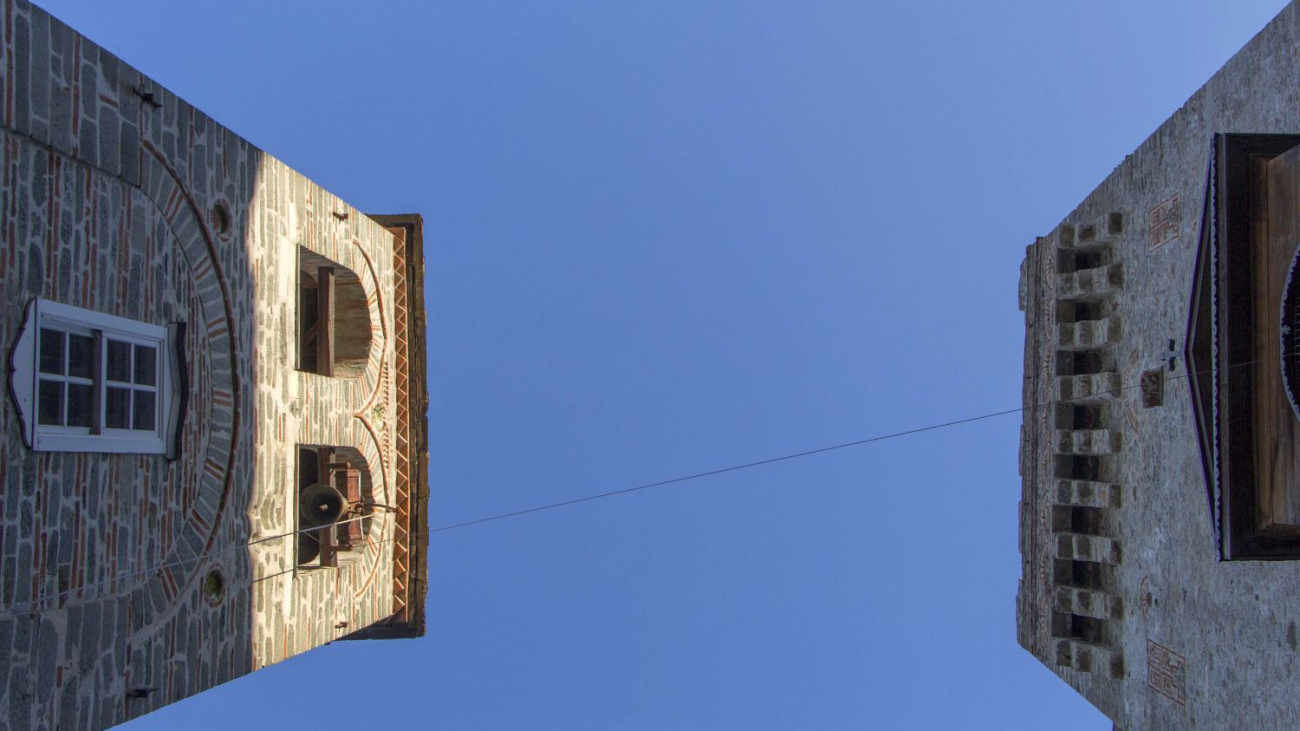 A dialog of the history of the Monastery resembling the dialogue of two tall buildings.