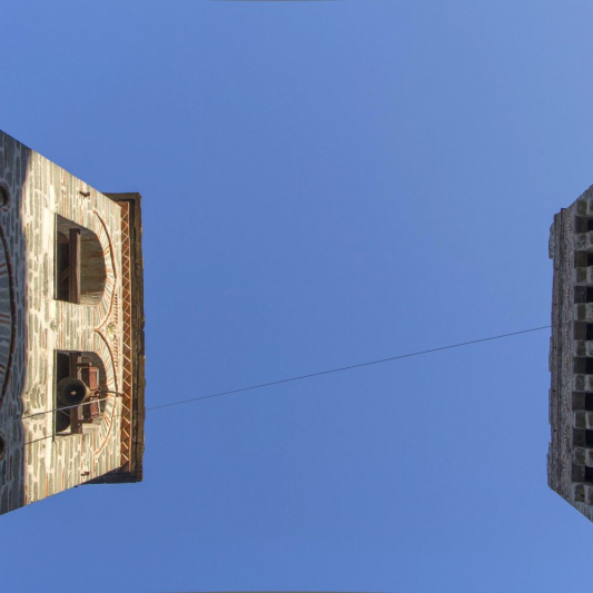 A dialog of the history of the Monastery resembling the dialogue of two tall buildings.