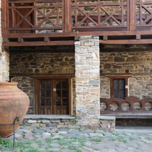 Detail from the courtyard, where a clay storage vessel (pithari) is visible.