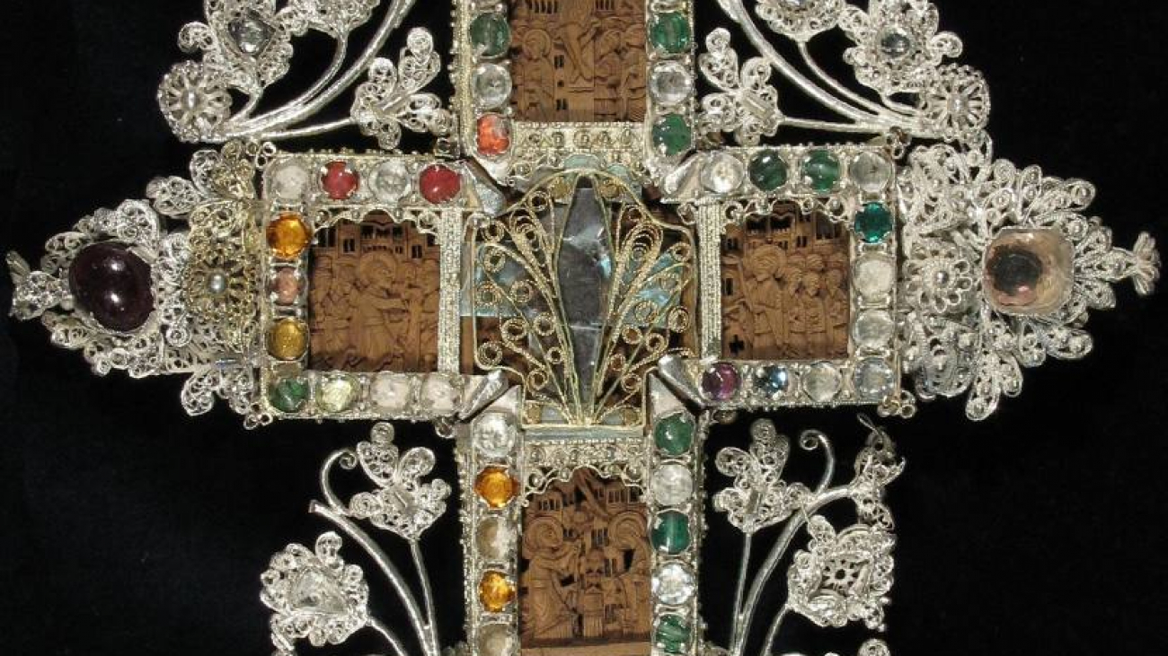 An exquisite blessings cross, set with precious stones on a wooden base. A work of the 18th century.