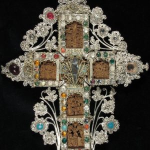 An exquisite blessings cross, set with precious stones on a wooden base. A work of the 18th century.