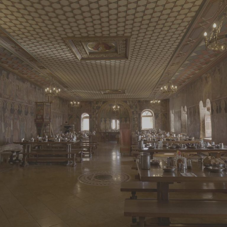 The refectory of the Monastery with its frescoes and the wooden roof of the Athonite architectural style.